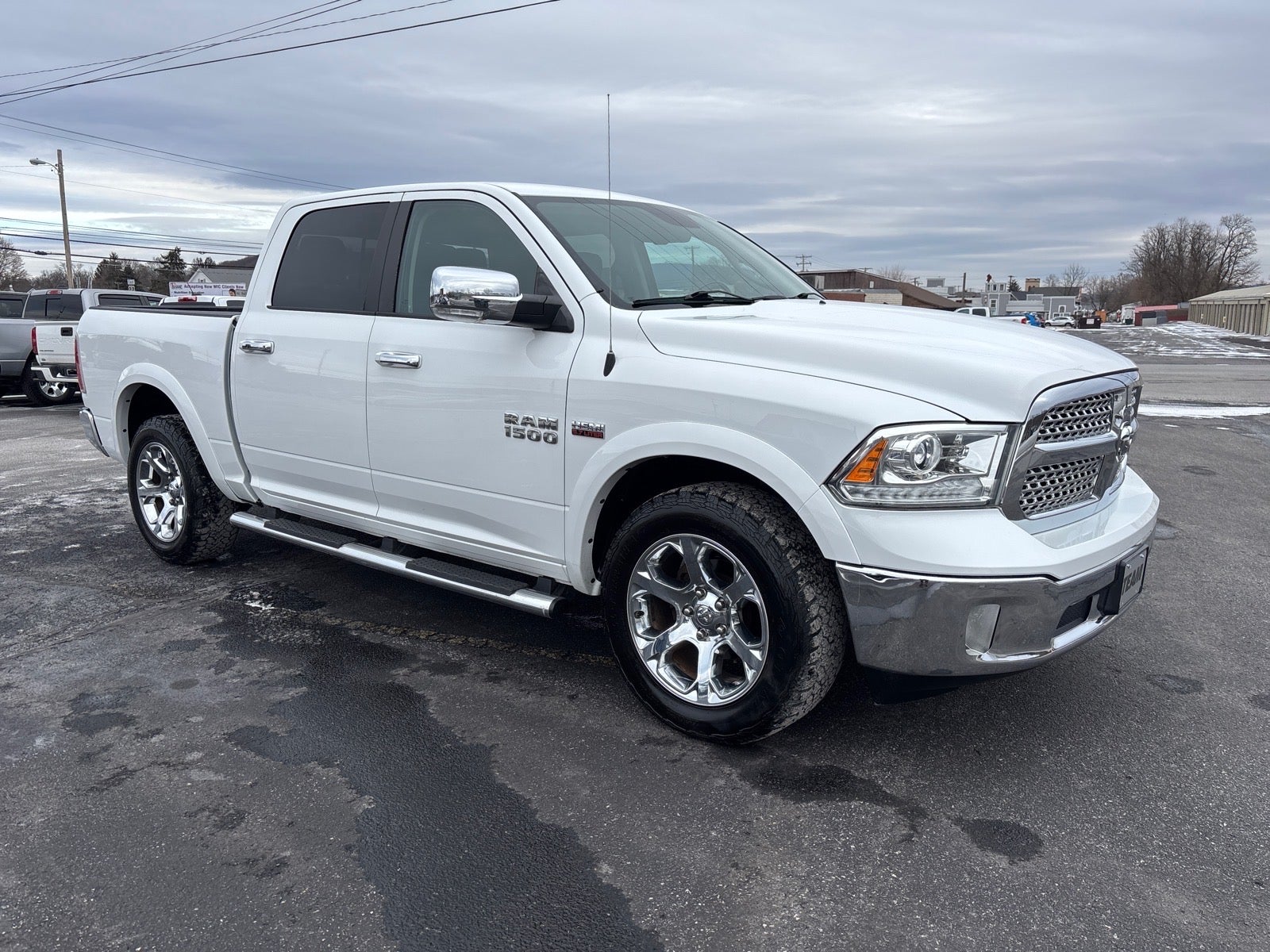 2016 RAM 1500 Laramie in White — front three-quarter view