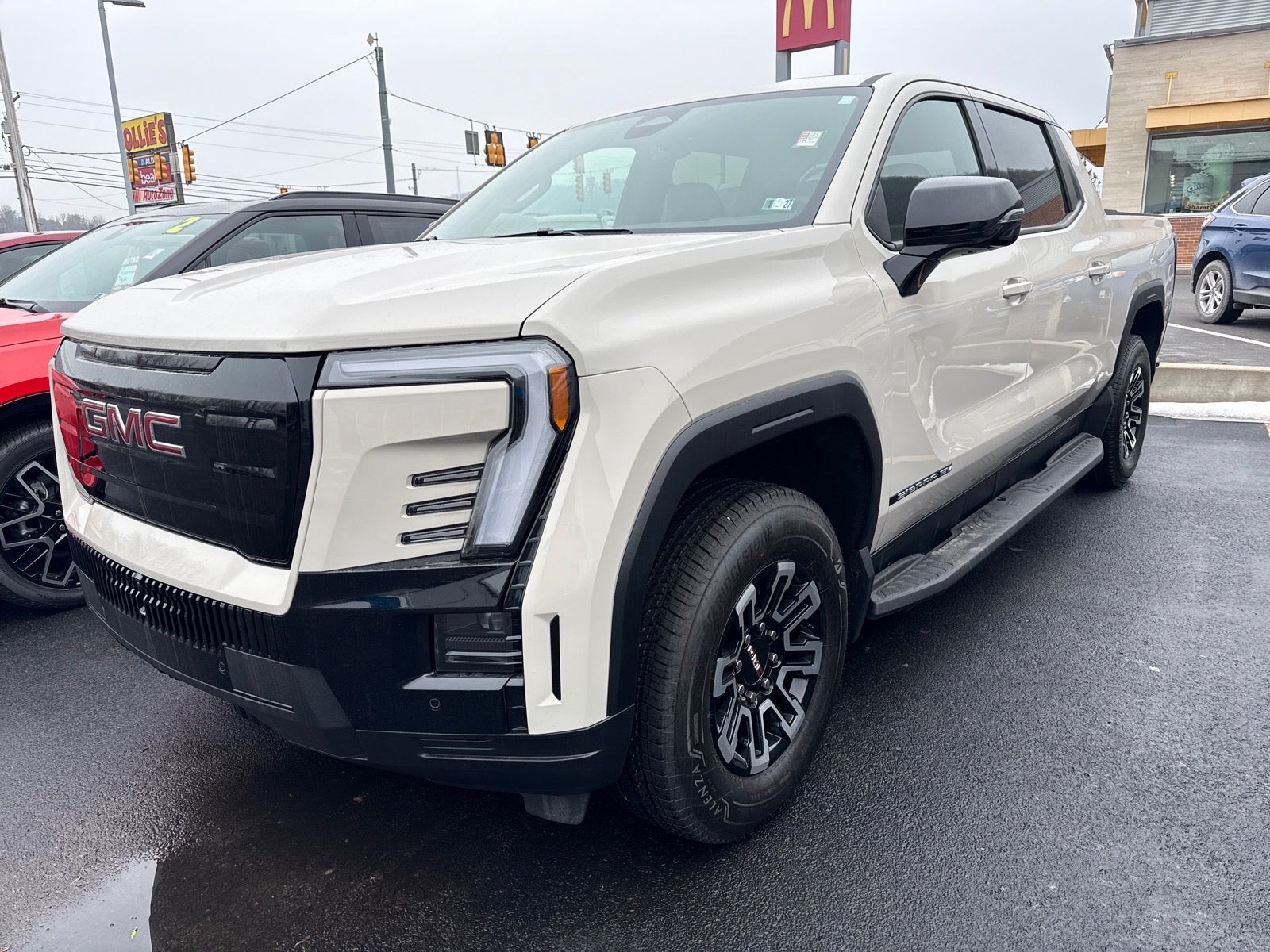 2026 GMC Sierra EV Elevation Extended Range in Coastal Dune — front three-quarter view