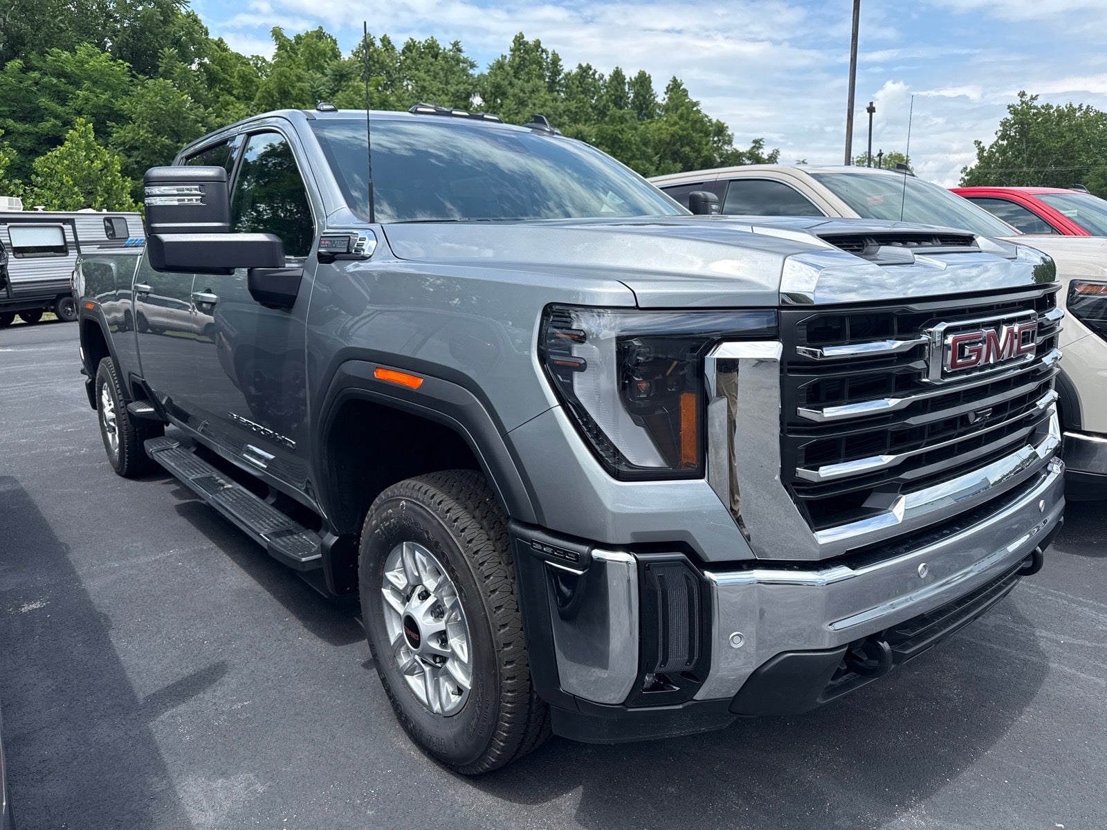 2026 GMC Sierra 2500 HD SLE in Sterling Metallic — front three-quarter view