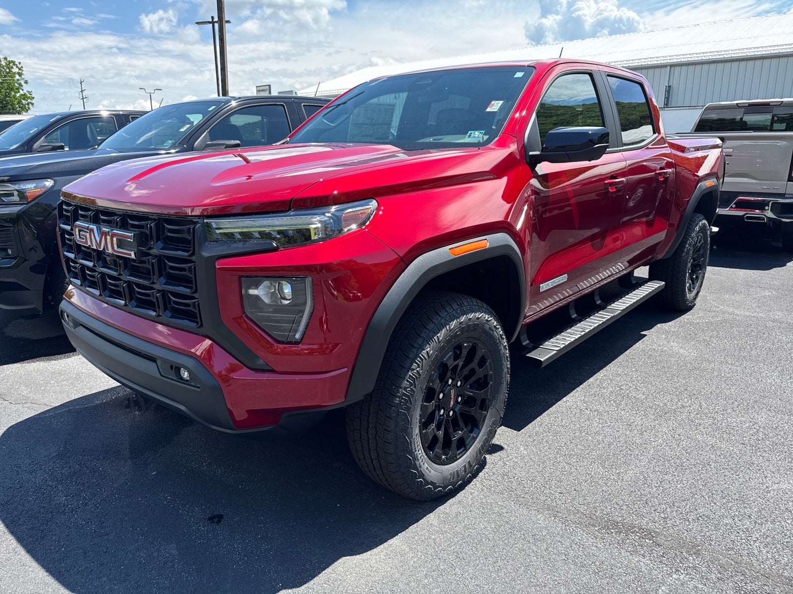2026 GMC Canyon Elevation in Volcanic Red Tintcoat — front three-quarter view