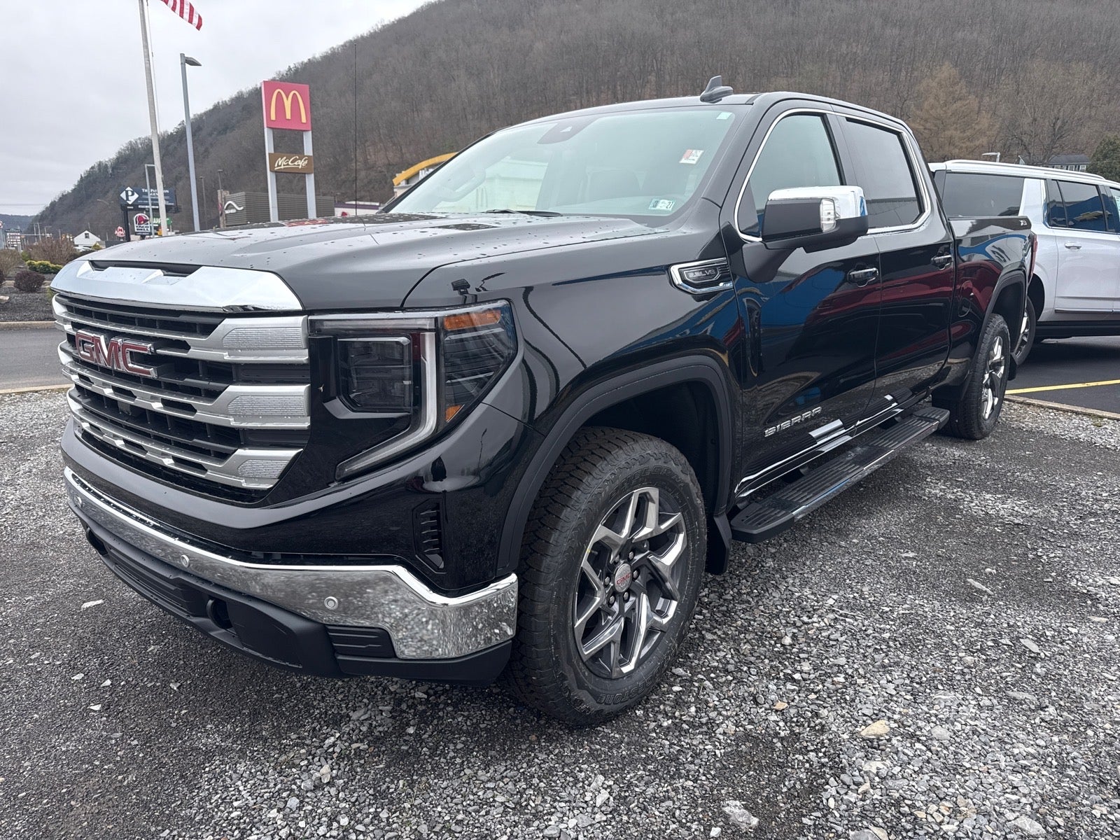 2026 GMC Sierra 1500 SLE in Onyx Black — front three-quarter view