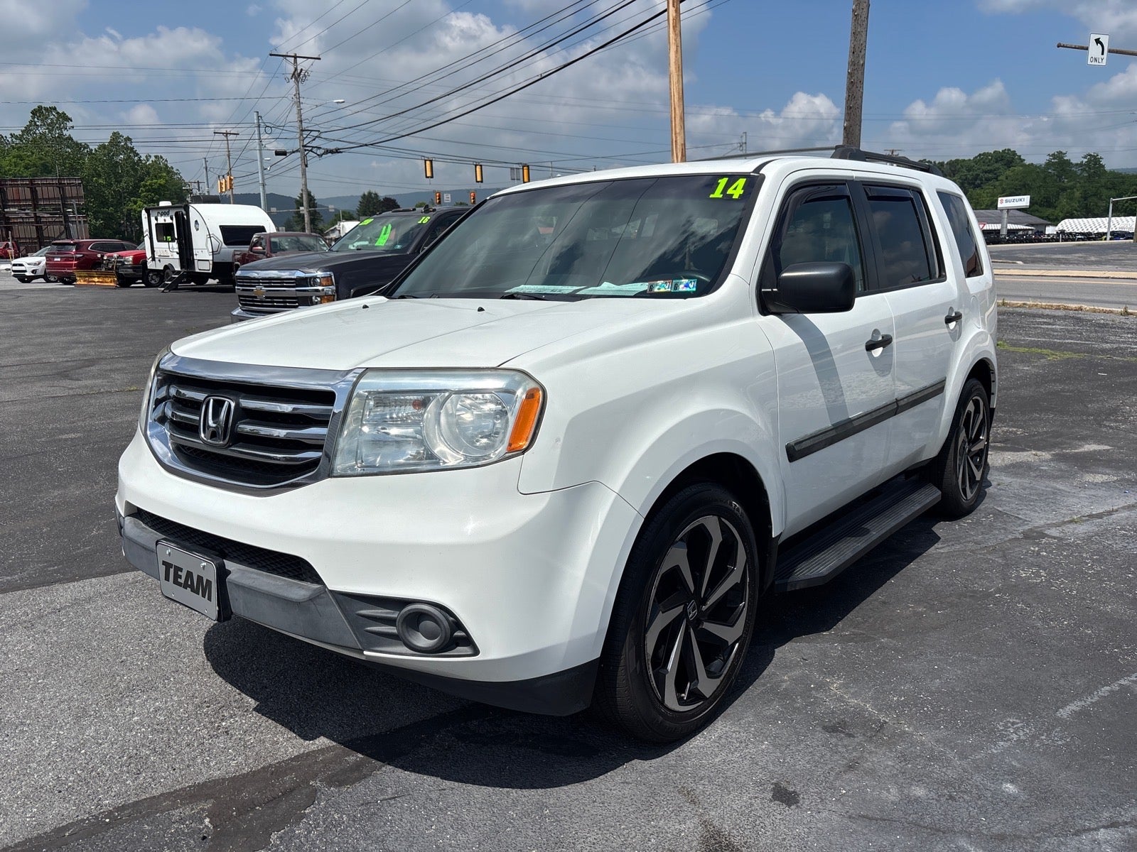 2014 Honda Pilot LX in White — front three-quarter view