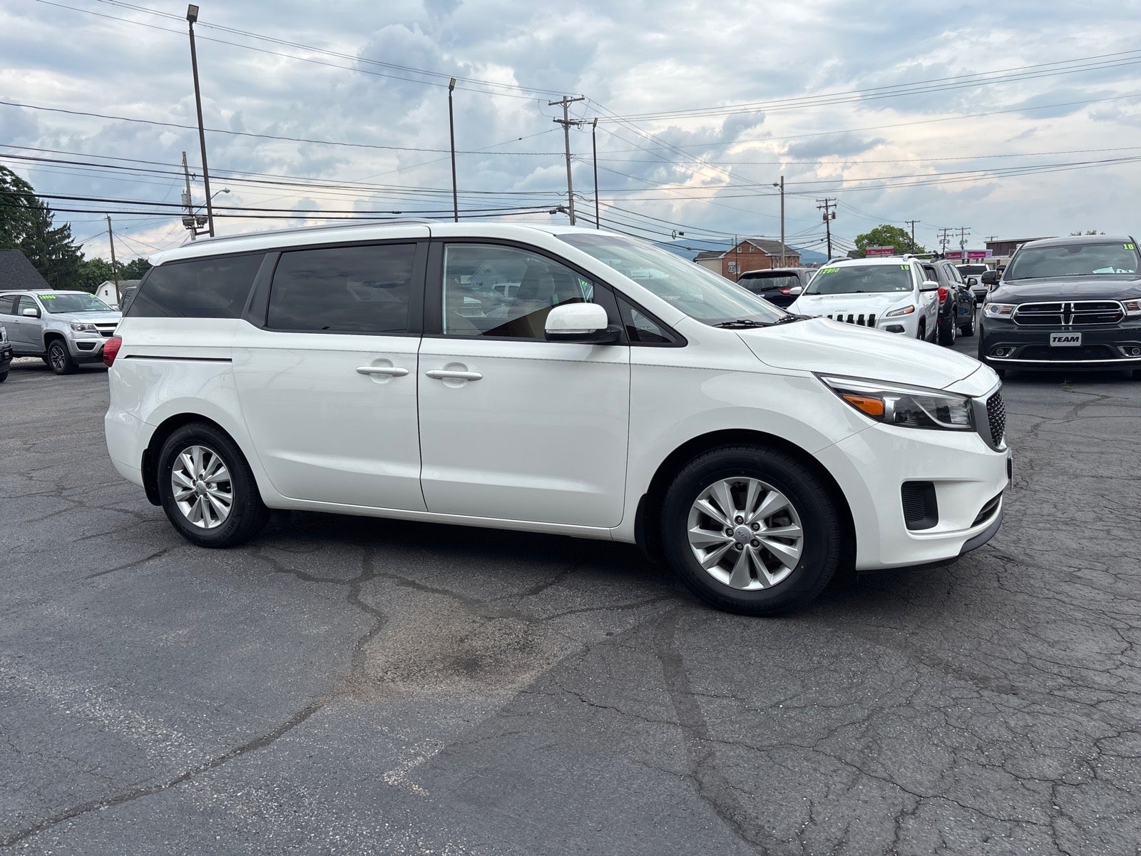 2016 Kia Sedona LX in White — front three-quarter view